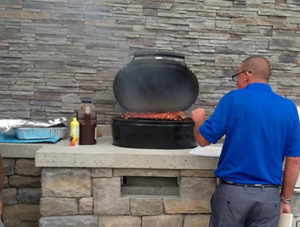 man cooking food in outdoor kitchen